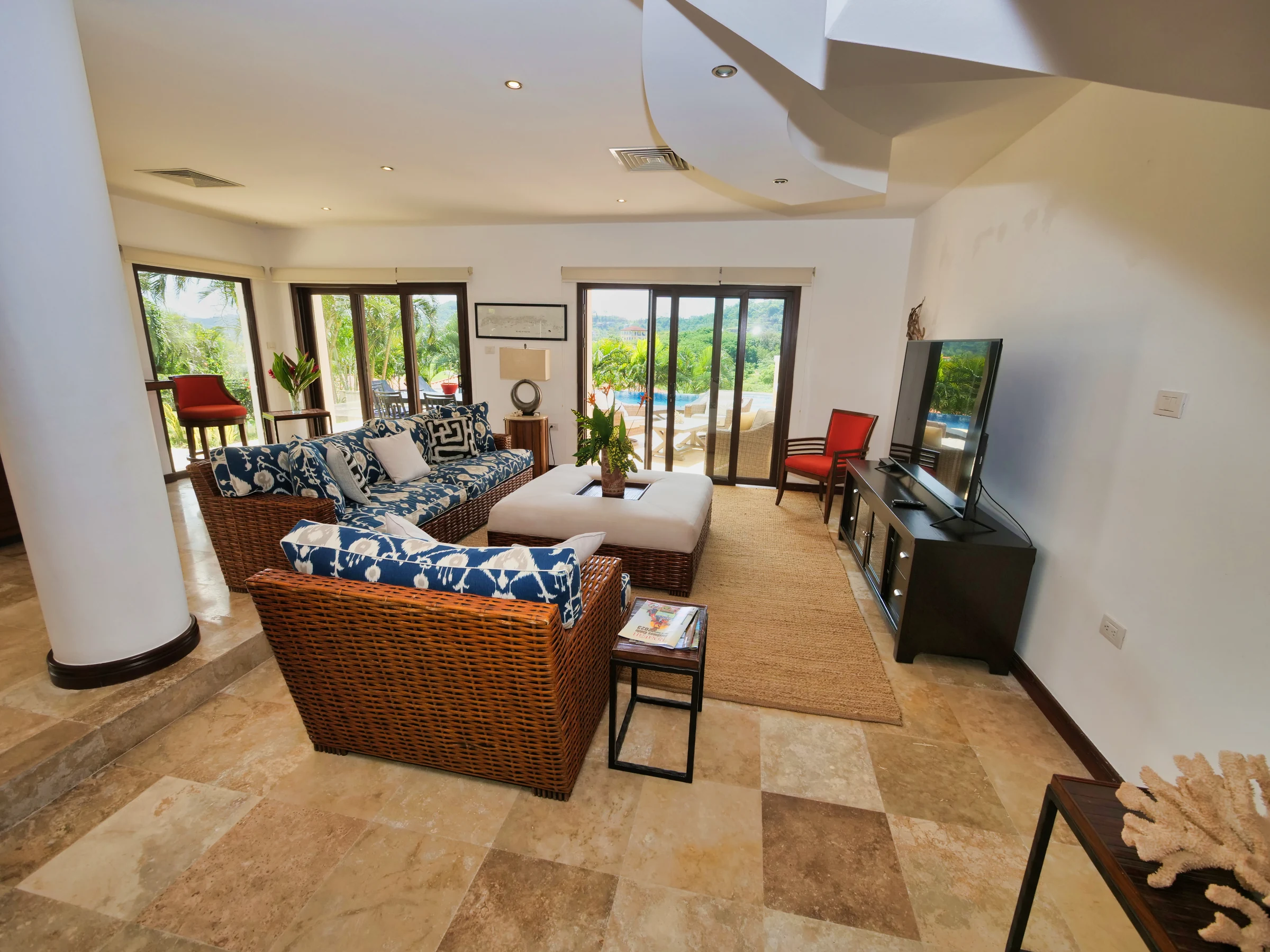 Open-plan living room with doors toward the pool